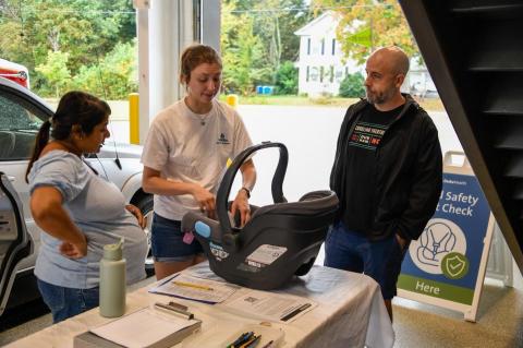 CPST Teaching family with a car seat on a table